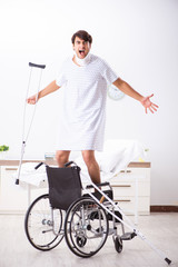 Young handsome man in wheelchair at the hospital 