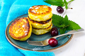 Hot fried delicious cheese cakes with powdered sugar