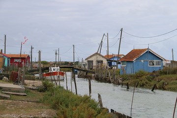 Fototapeta na wymiar Colourful house near canal and boat