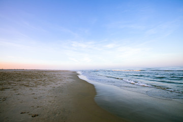 Fototapeta premium Looking down Peaceful Beach as Sunset begins
