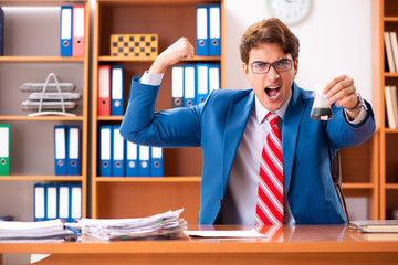 Young handsome politician sitting in office 