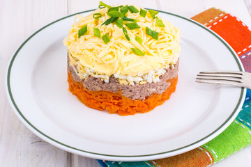 Portion salad with carrots on white wooden table