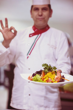 Chef showing a plate of tasty meal