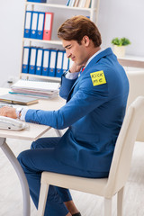 Office prank with kick me message on sticky note