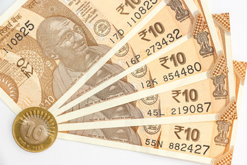 Close up view of brand new indian 10 rupees banknotes and coin.