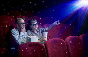 Lovely couple watching 3D movie with little sparkling stars around