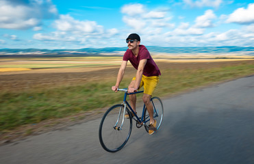 Fototapeta na wymiar Natural view with cyclist going somewhere with stylish bike