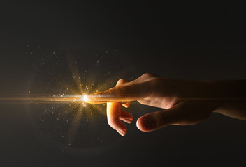 Female finger touching a beam of light