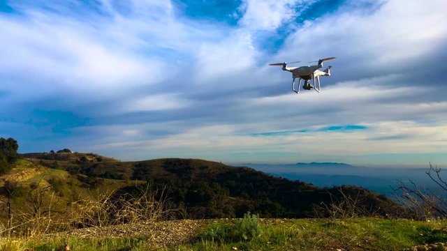 Drone Flying abobe the mountain tops blue sky green grass sun set Ojai phantom 