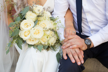Obraz na płótnie Canvas Bride and groom holding with a bouquet.