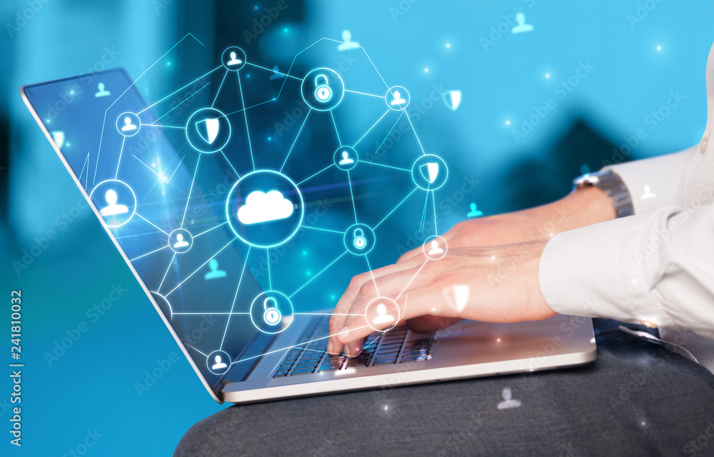 Poster Hand using laptop with centralized cloud computing system and network security concept
