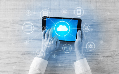 Hand touching tablet with cloud computing and online storage concept
