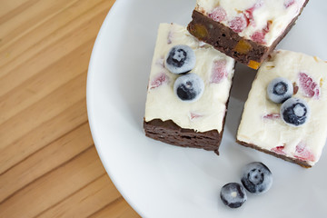 Homemade brownies stack or chocolate cake with rum fruit and honey, strawberry cream cheese and...