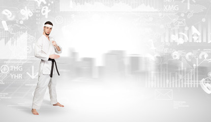 Young karate trainer doing karate tricks on the top of a metropolitan city
