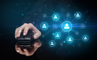 Hand using wireless mouse in a dark environment with human network concept