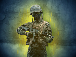 Fototapeta premium Hazard, menace soldier in a ruined crumbly building with arms on his hand 