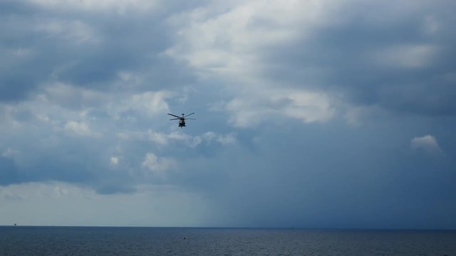 Helicopter heading and landing on an offshore oil rig , service travel to oil and gas platform and drilling rig in offshore locations