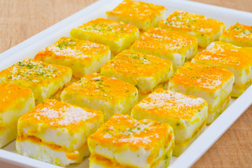 Paneer Burfi or Paneer Kesar Burfi is a Traditional Indian Mithai or Sweet Dish Prepared From Freshly Made Paneer, Mawa, Milk or Cottage Cheese on Wooden Background