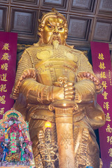 A golden giant statue at Che Kung Temple, landmark and popular for tourist attractions in Hong Kong; Hong Kong, China, 18 December 2018