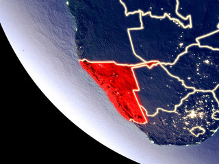 Orbit view of Namibia at night with bright city lights. Very detailed plastic planet surface.