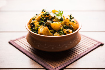 Fenugreek potato sabzi or Aloo Methi masala is healthy Indian Cuisine. served in a bowl or karahi. selective focus