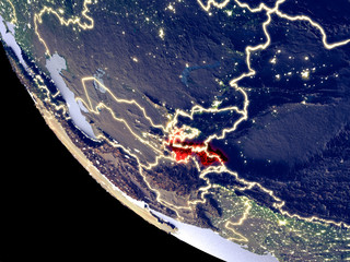 Orbit view of Tajikistan at night with bright city lights. Very detailed plastic planet surface.