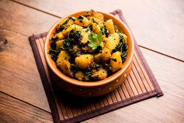 Fenugreek potato sabzi or Aloo Methi masala is healthy Indian Cuisine. served in a bowl or karahi. selective focus