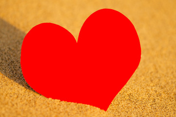 Red heart on white sand beach copyspace woman at sunset by the ocean.happy valentine's day and mother's day copy space
