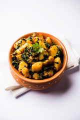 Fenugreek potato sabzi or Aloo Methi masala is healthy Indian Cuisine. served in a bowl or karahi. selective focus