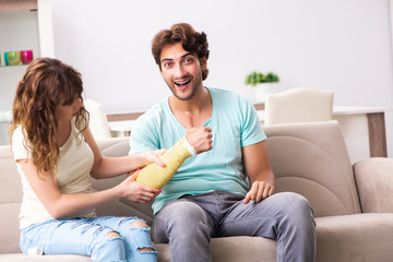 Young family helping each other after injury