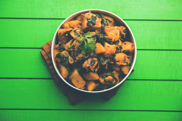 Fenugreek potato sabzi or Aloo Methi masala is healthy Indian Cuisine. served in a bowl or karahi....