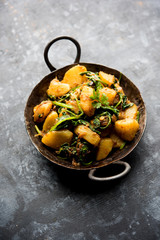 Aloo Palak sabzi - Potato cooked with spinach with added spices. a healthy Indian main course recipe. Served in a bowl, selective focus