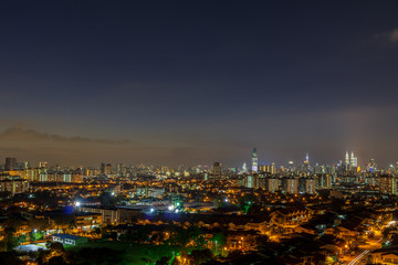 Fototapeta na wymiar Sunset view of downtown Kuala Lumpur, a capital of Malaysia. Its modern skyline is dominated by the 451m-tall Petronas Twin Towers.