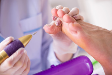 Podiatrist treating feet during procedure