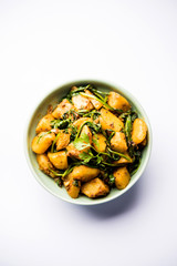 Aloo Palak sabzi - Potato cooked with spinach with added spices. a healthy Indian main course recipe. Served in a bowl, selective focus