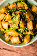 Aloo Palak sabzi - Potato cooked with spinach with added spices. a healthy Indian main course recipe. Served in a bowl, selective focus