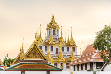 Loha Prasart metal buddhist temple golden pagoda sunset sky with cloud