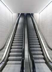 vertical view of a long an empty escalator in a train station