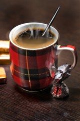 Mug with hot black coffee standing on the table