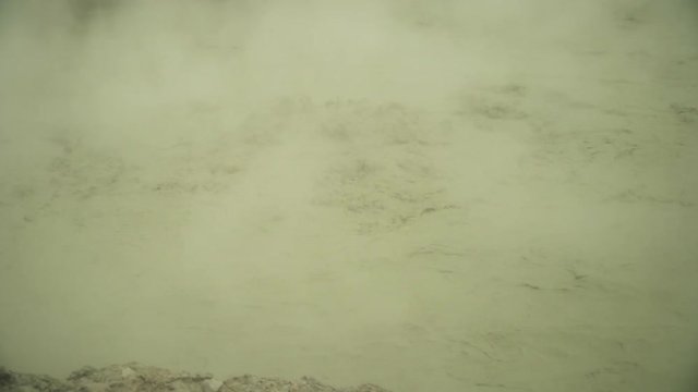 mud volcano Kawah Sikidang, geothermal activity and geysers. plateau Dieng with volcanic activity Indonesia. Famous tourist destination of Sikidang Crater it still generates thick sulfur fumes.