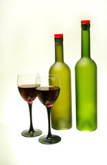 Two glasses of wine and two bottles Isolated on white