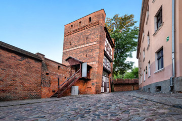 Medieval leaning tower - famous landmark in Torun, Poland - obrazy, fototapety, plakaty