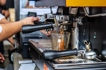Coffee pouring machine close up in modern cafe