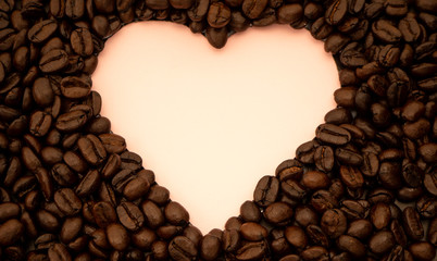 Heart shaped coffee beans on pink