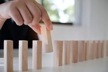 Planning risk and strategy in businessman gambling placing wooden block.Business concept for growth...