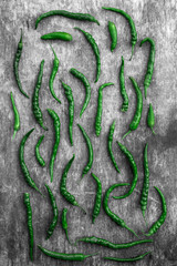 Green paprika peppers on old rustic wooden background