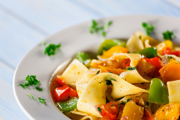 Pasta with vegetables on wooden background