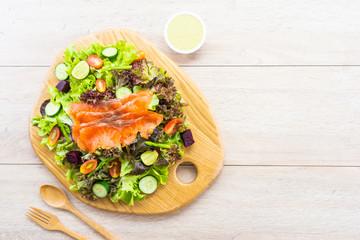 Raw Smoked salmon meat fish with fresh green vegetable salad