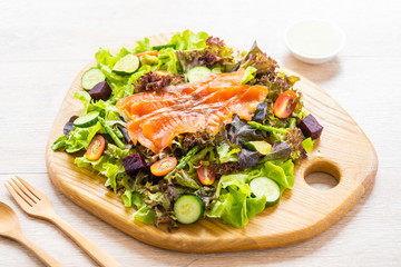Raw Smoked salmon meat fish with fresh green vegetable salad
