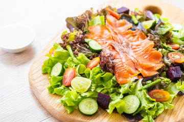 Fototapeta na wymiar Raw Smoked salmon meat fish with fresh green vegetable salad